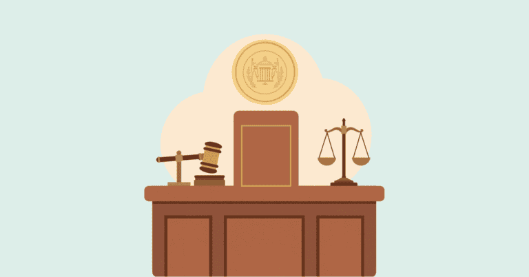 Judicial desk with a gavel, scales of justice, and a large book, symbolizing law and fairness.